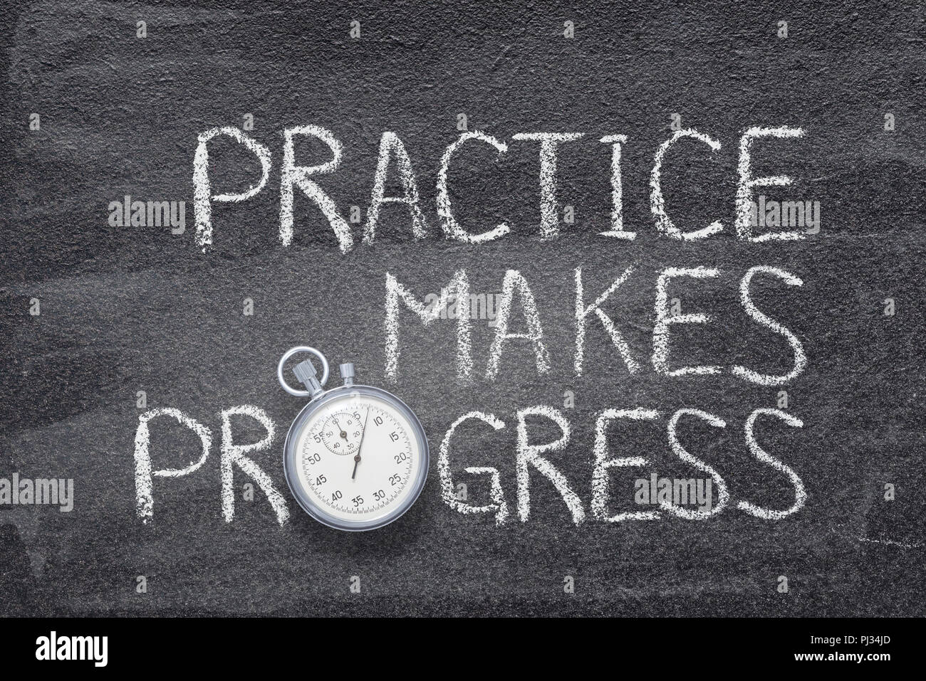 practice makes progress phrase handwritten on chalkboard with vintage precise stopwatch used instead of O Stock Photo