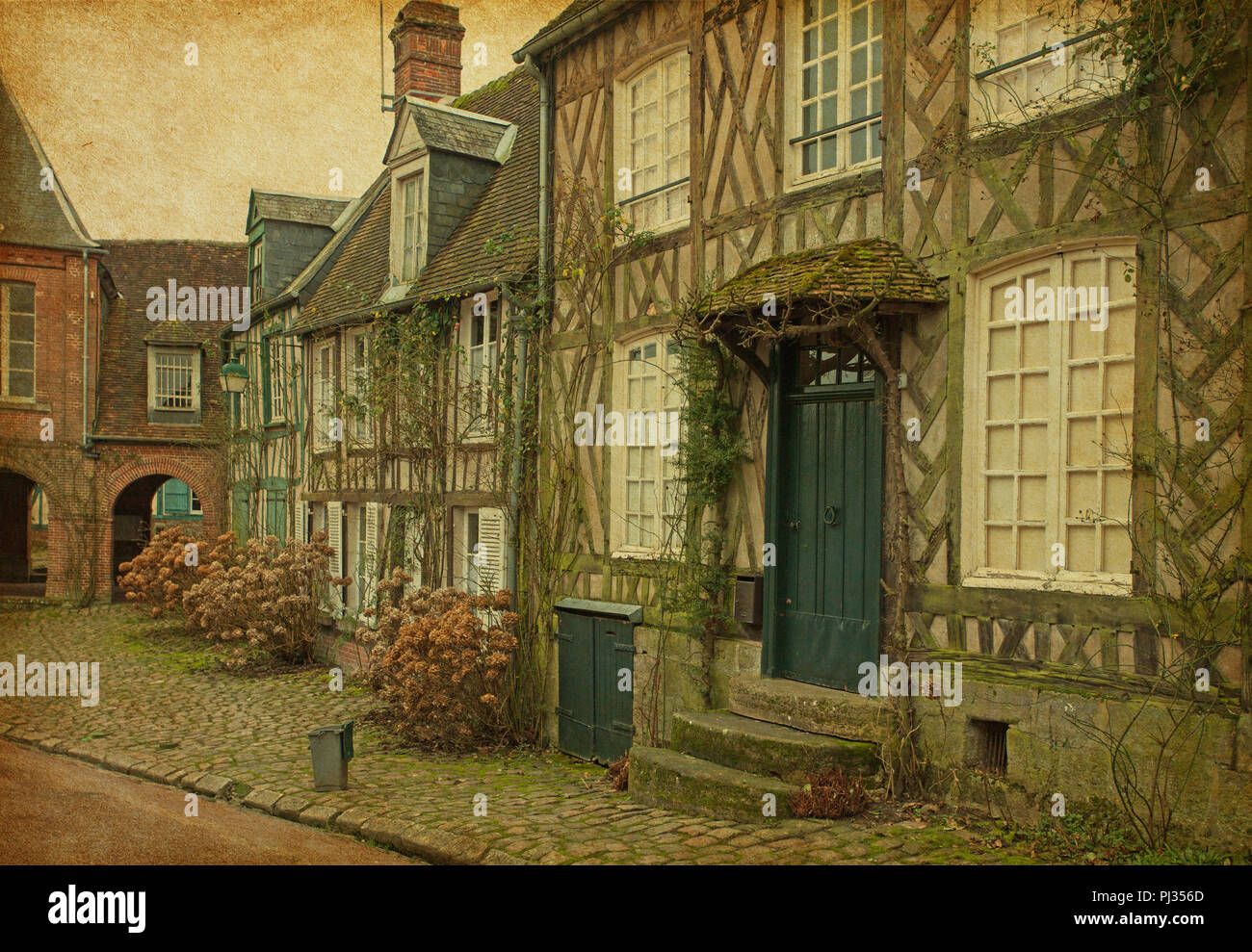 Old houses  in medieval village. Gerberoy, France. Added paper texture. Stock Photo