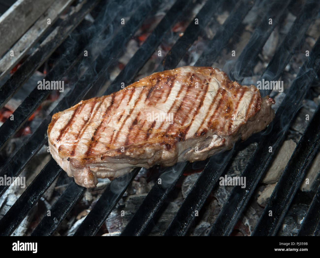 beef steak cooking on an open flame grill Stock Photo Alamy