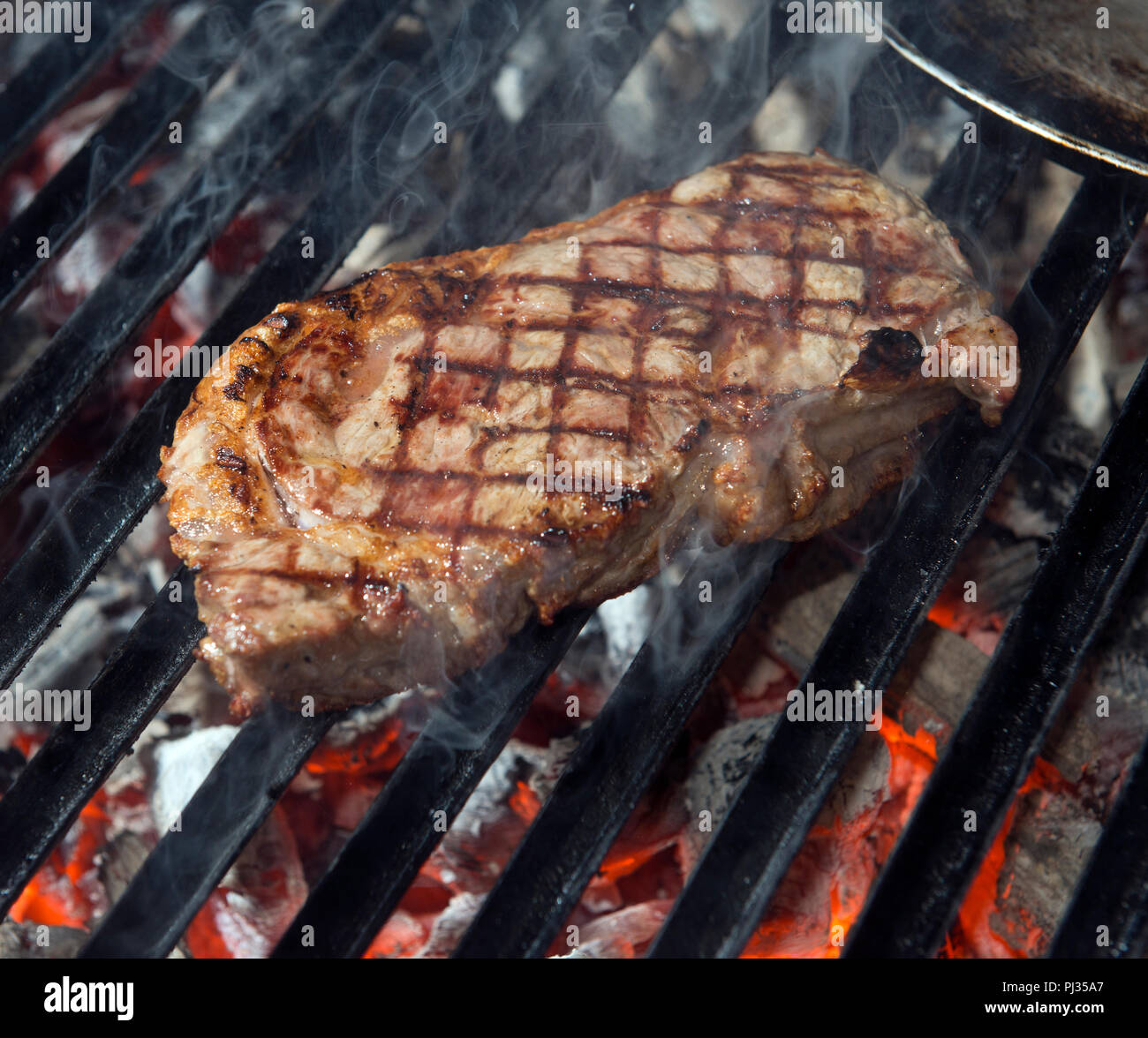 beef steak cooking on an open flame grill Stock Photo - Alamy
