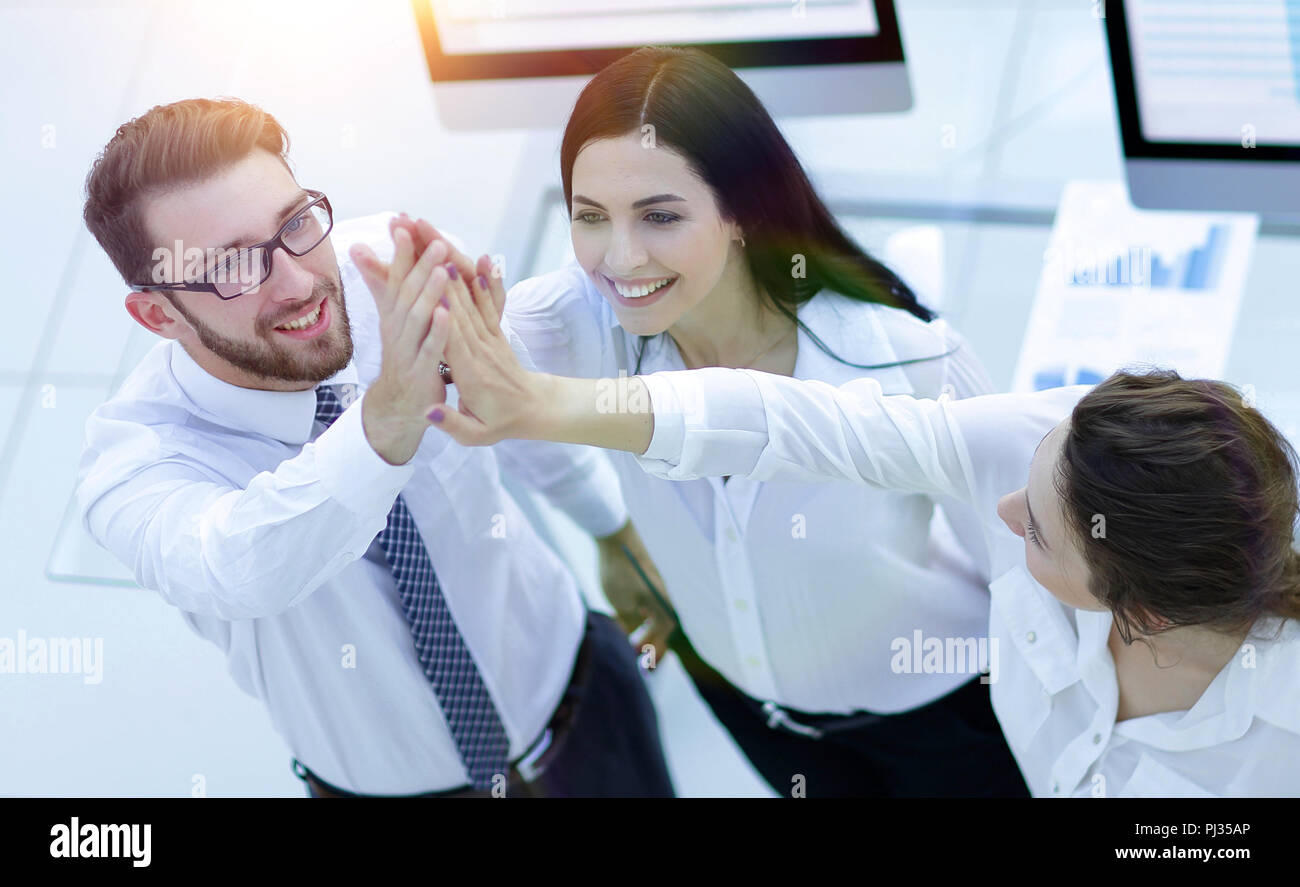 successful business team giving each other a high five Stock Photo - Alamy