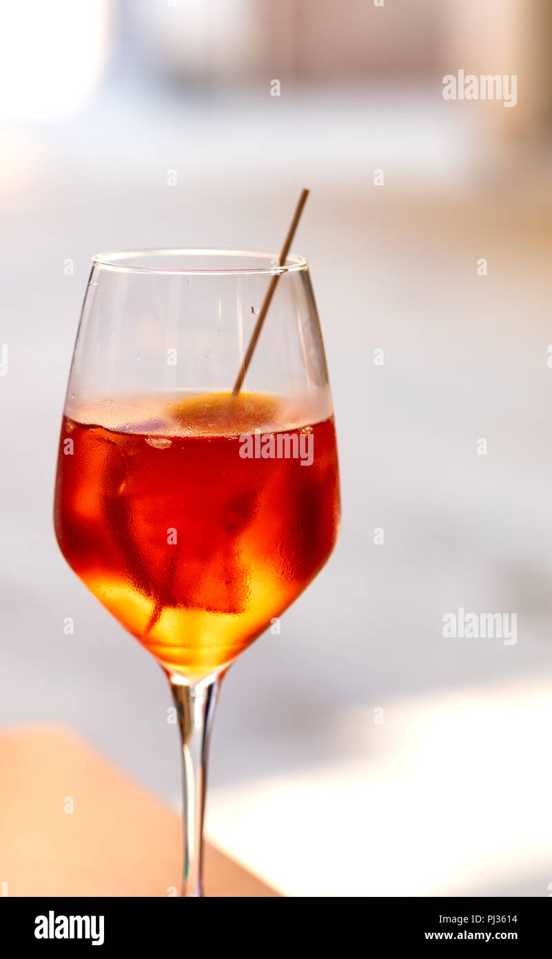 aperol cocktail, red and orange color, on blurred background with free space for text Stock Photo