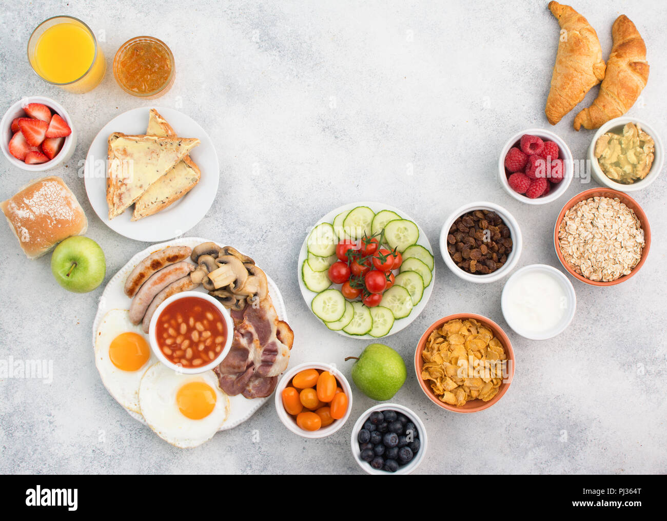 Continental and English breakfast, fried eggs, sausages, bacon and ...