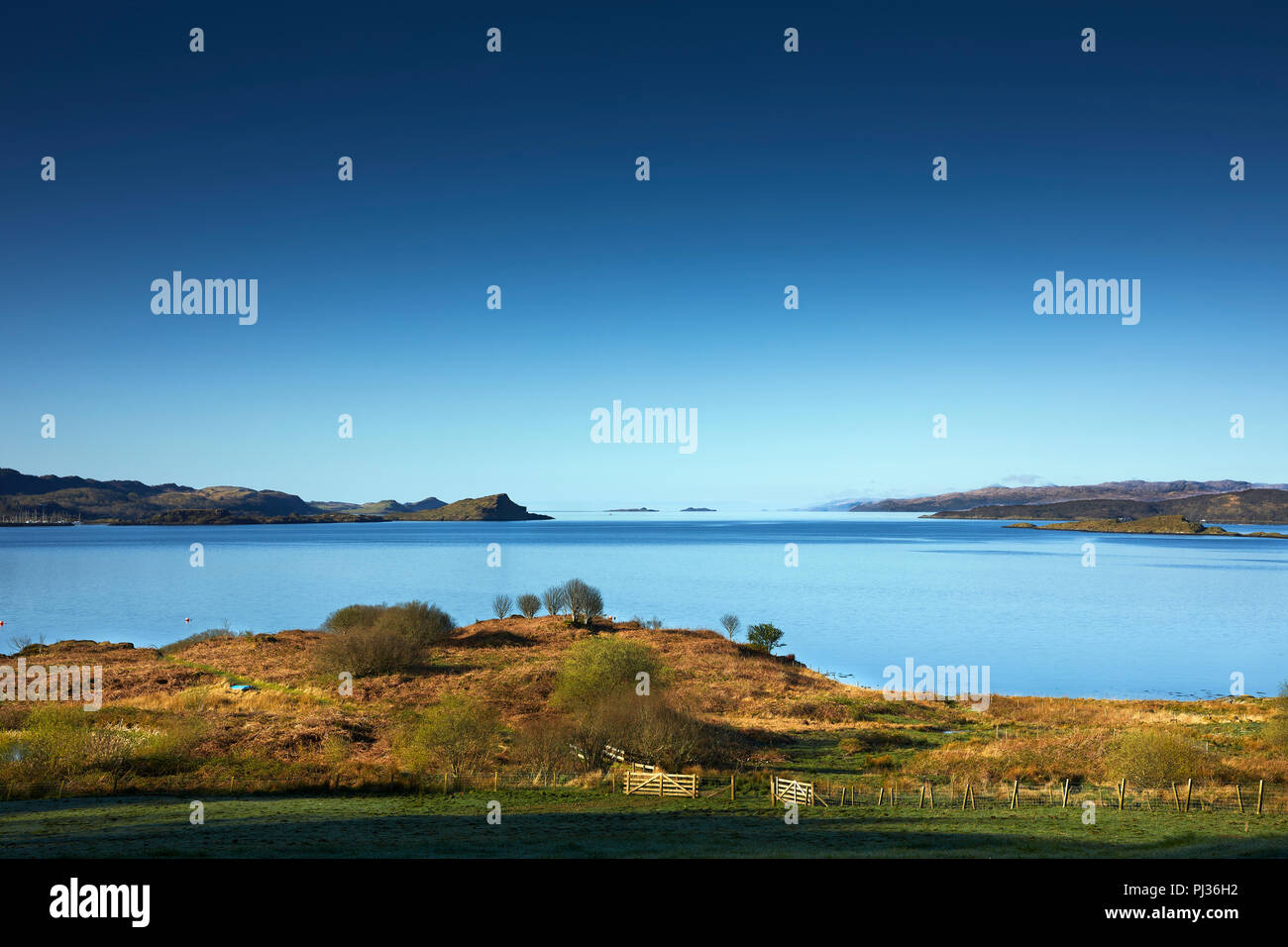 Early morning. Looking due south from Loch Melfort Hotel. Across Asknish Bay towards Craobh Haven in the distance. Arduaine, Argyll, Scotland Stock Photo