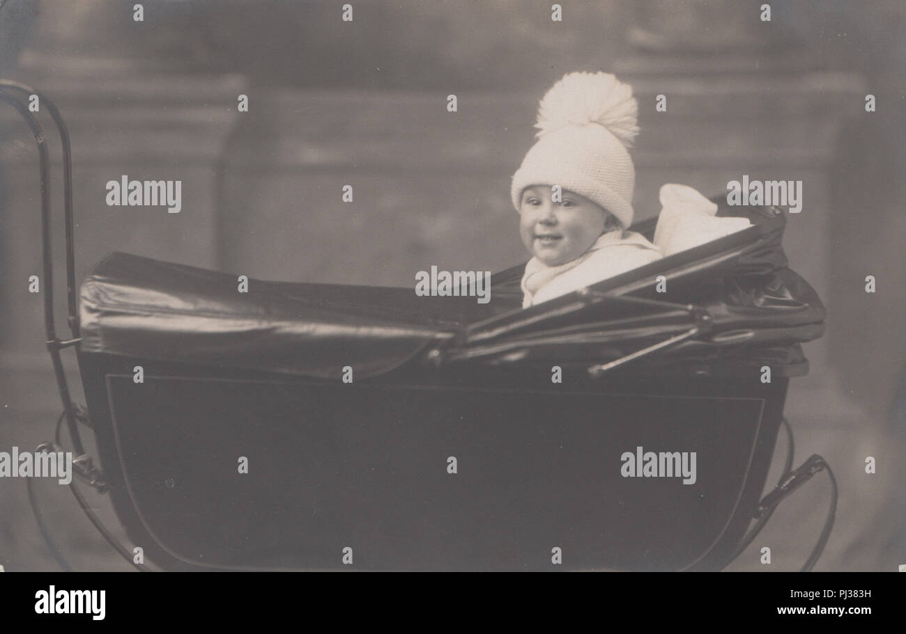 Vintage 1923 Photograph of a 15 Month Old Boy Called Billie Sitting Proudly In His Beautiful Pram Stock Photo