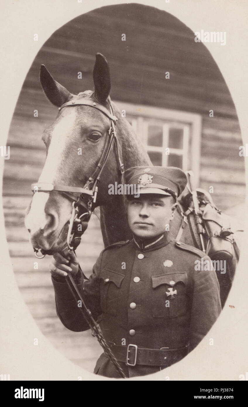 Vintage Photograph of a German Soldier Stood Next To His Horse. The Soldier is Wearing an Iron Cross. Stock Photo