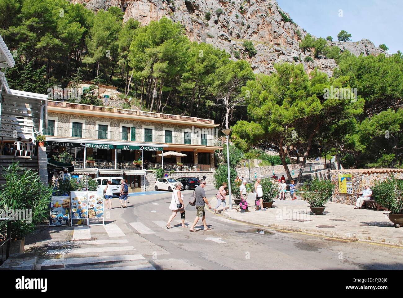 Tourists walk in the port town of Sa Calobra on the Spanish island of Majorca on September 6, 2017. The town is home to the Torrent de Pareis canyon. Stock Photo