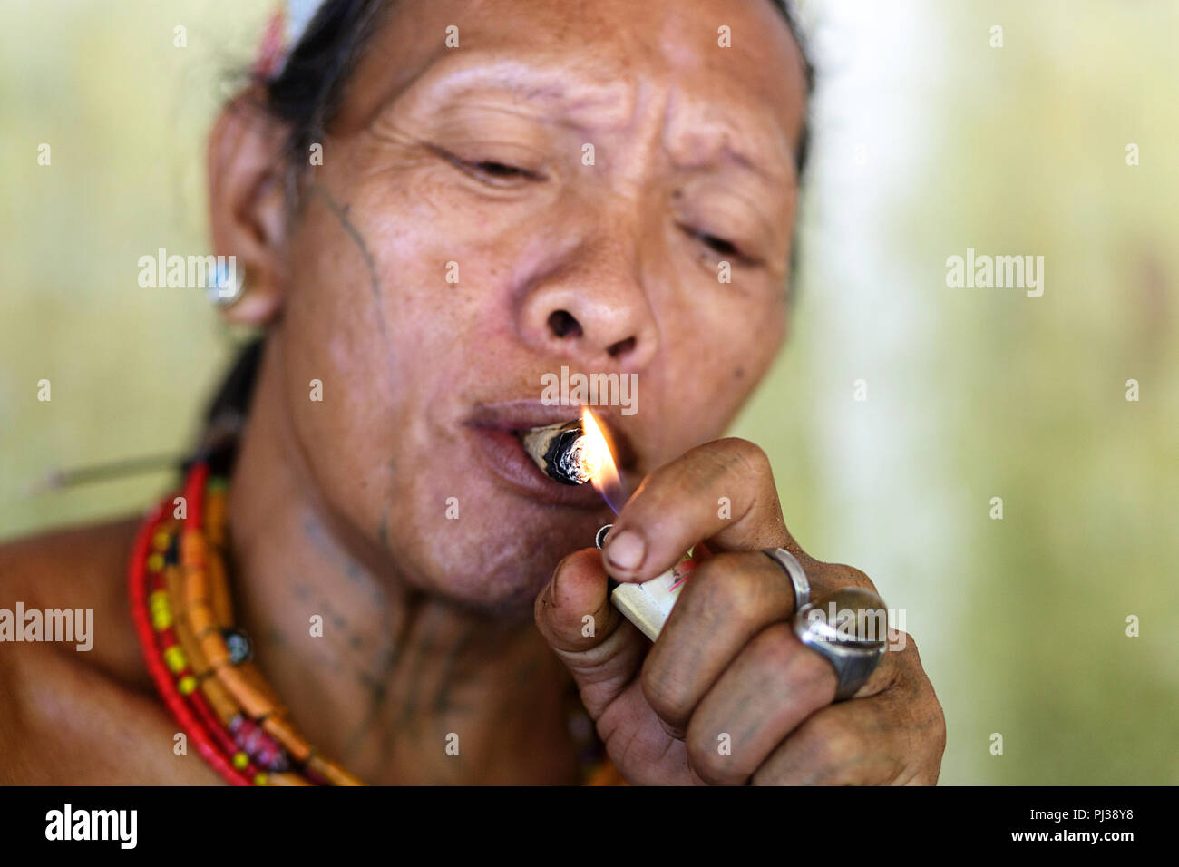 Mentawai man smoking , Siberut, Sumatra, Indonesia Stock Photo