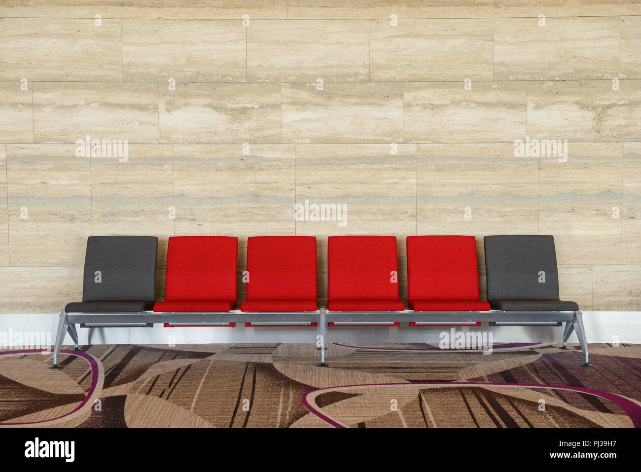 Rows chairs in the waiting area with marble background Stock Photo