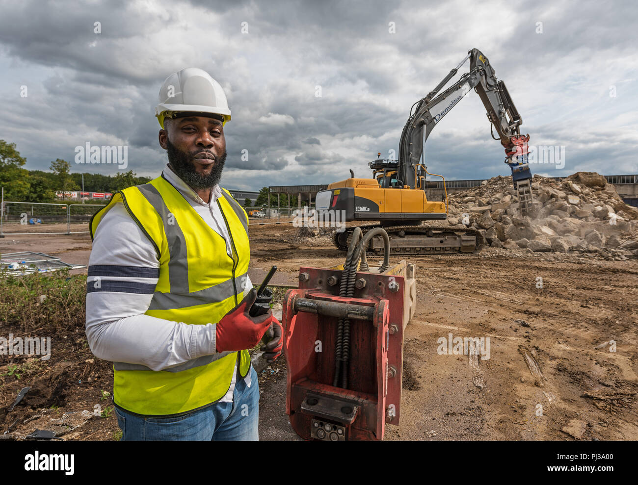 Site manager overseeing groundwork facing camera Stock Photo