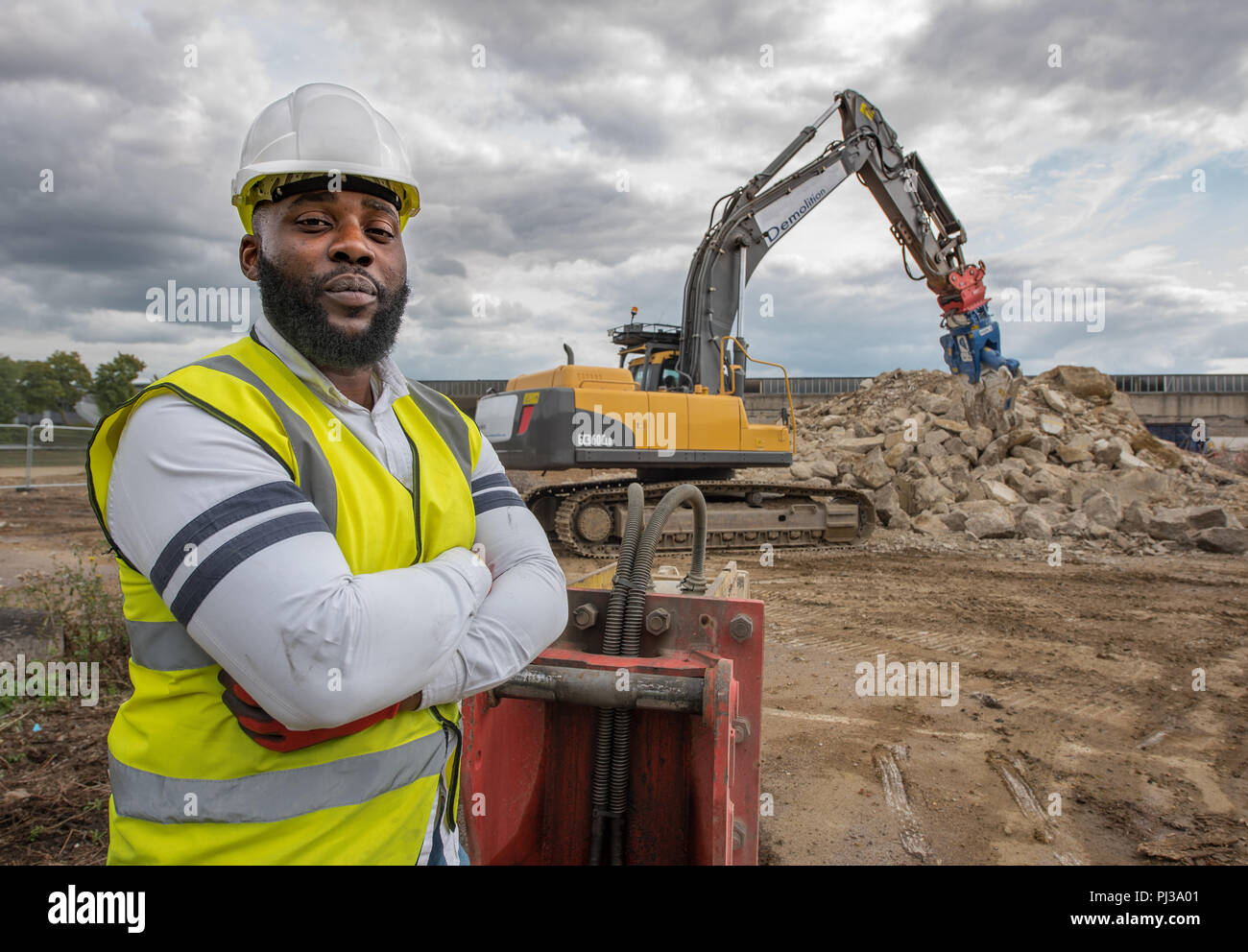 Site manager overseeing groundwork facing camera Stock Photo