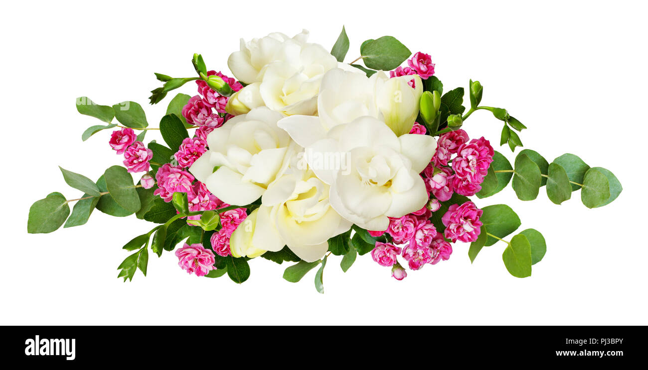 Fresh white freesia and small pink flowers with eucalyptus leaves in arrangement isolated on white background Stock Photo