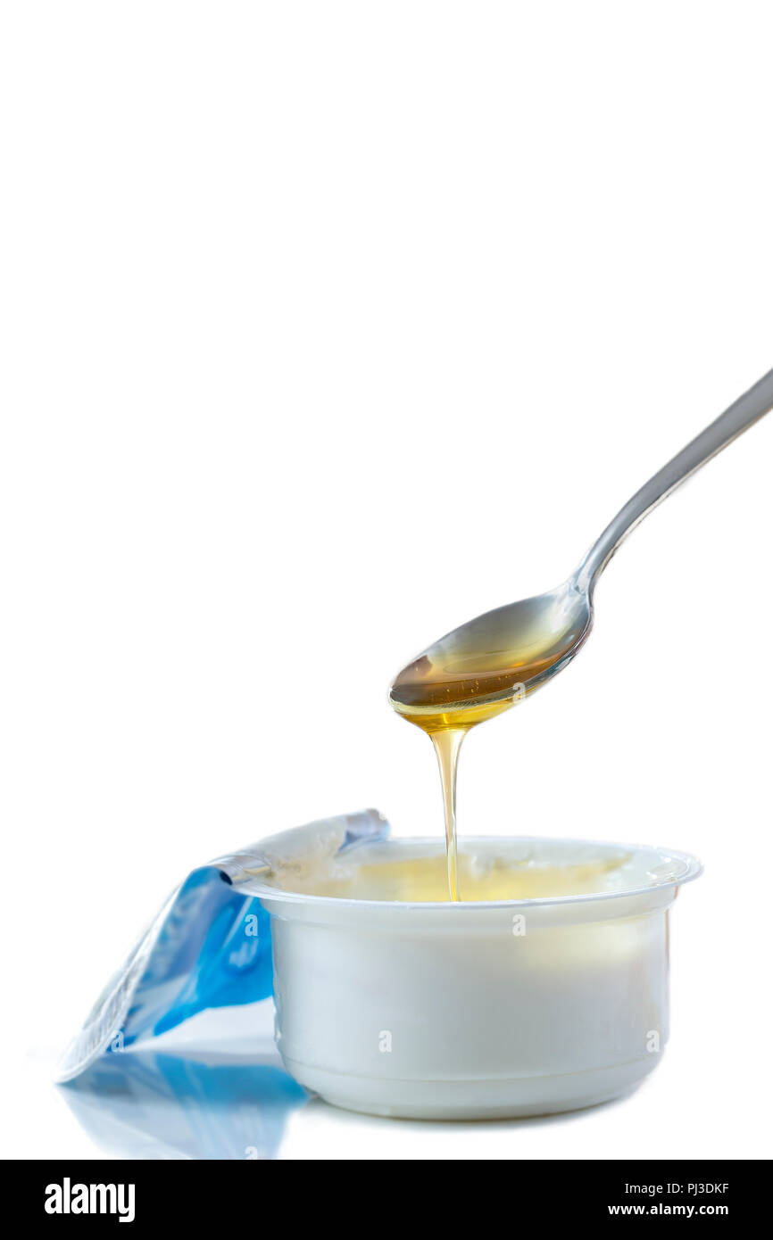 Honey Yogurt. Greek yogurt with honey in a pot with honey product Stock Photo