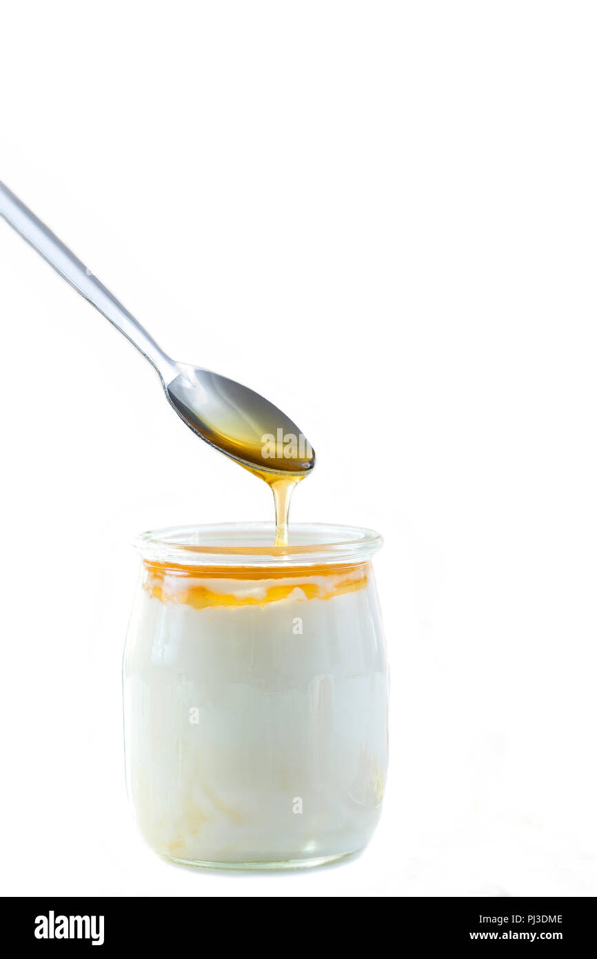 Honey Yogurt. Greek yogurt with honey in a glass jar with honey product Stock Photo