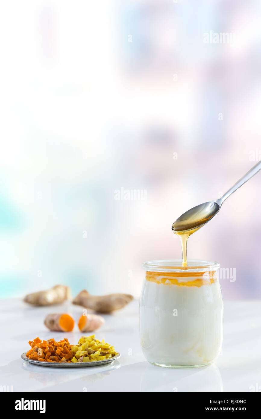Honey Yogurt. Greek yogurt with honey in a glass pot with honey product Stock Photo