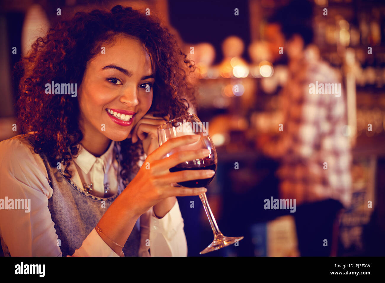 Portrait of young woman having red wine Stock Photo