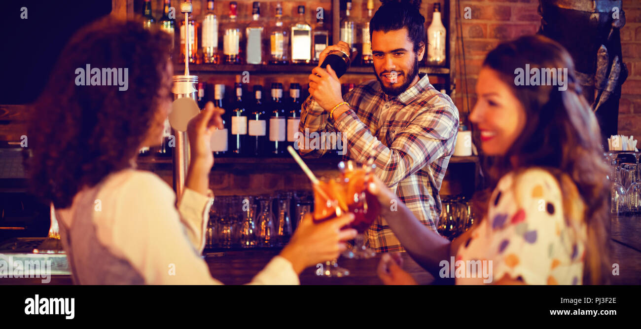 Bartender mixing a cocktail drink in cocktail shaker Stock Photo