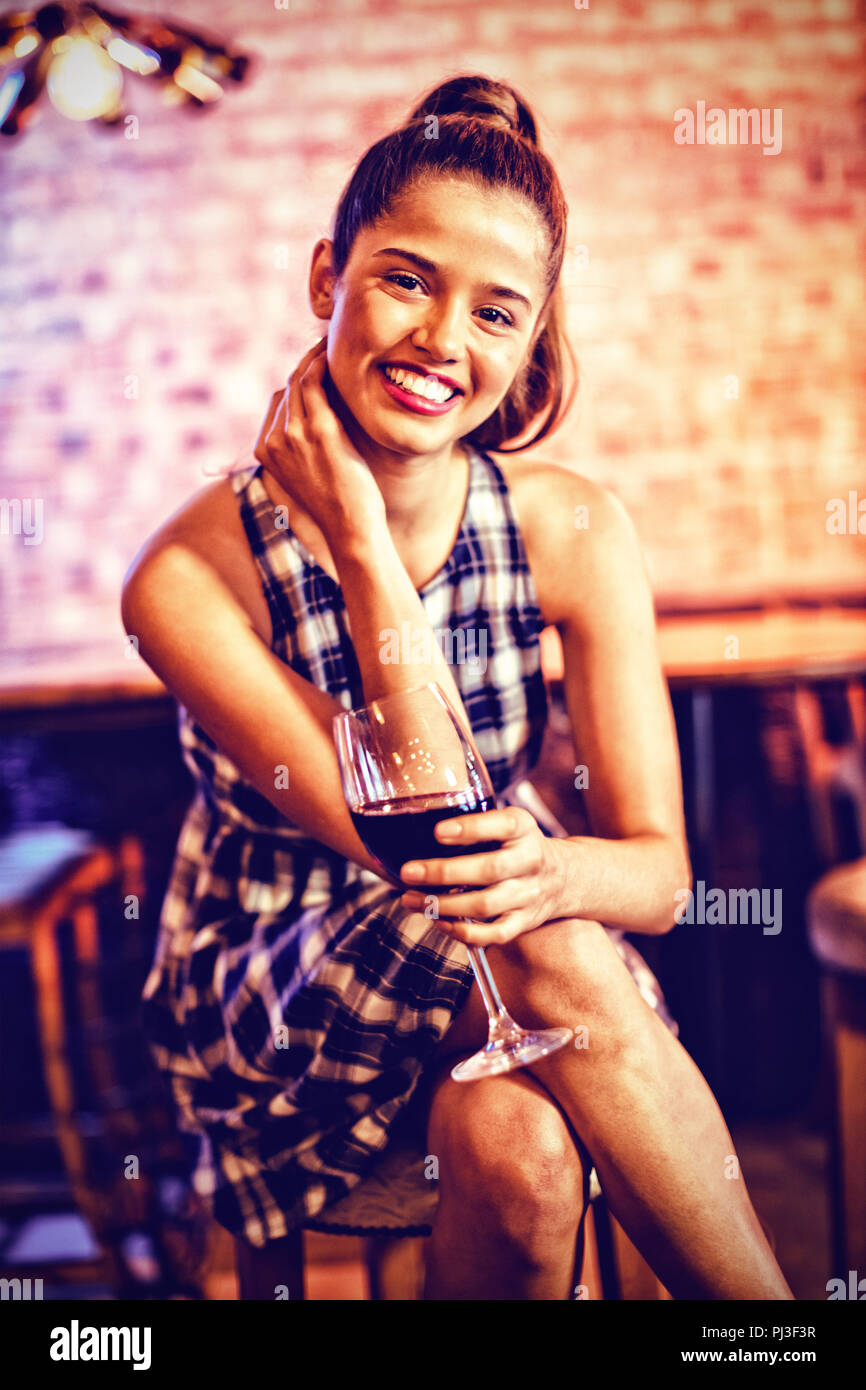 Portrait of young woman having red wine Stock Photo - Alamy