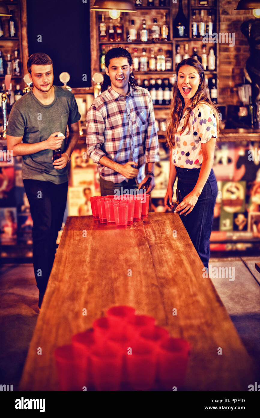 Group of happy friends playing beer pong game Stock Photo Alamy