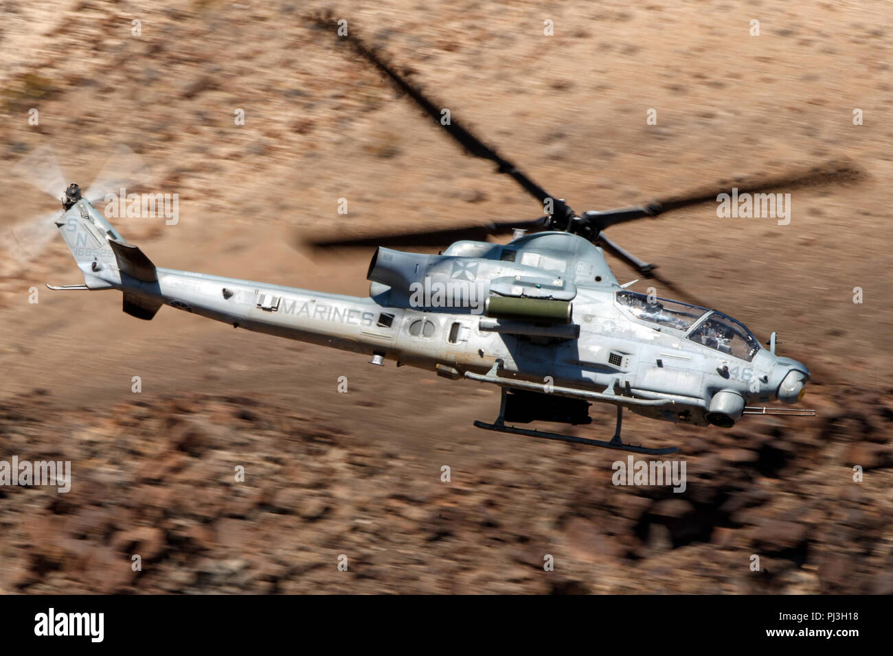 United States Marines Corps Bell AH-1Z Viper (SN 168529) flies low level on the Jedi Transition through Star Wars Canyon / Rainbow Canyon, Death Valley National Park, Panamint Springs, California, United States of America Stock Photo