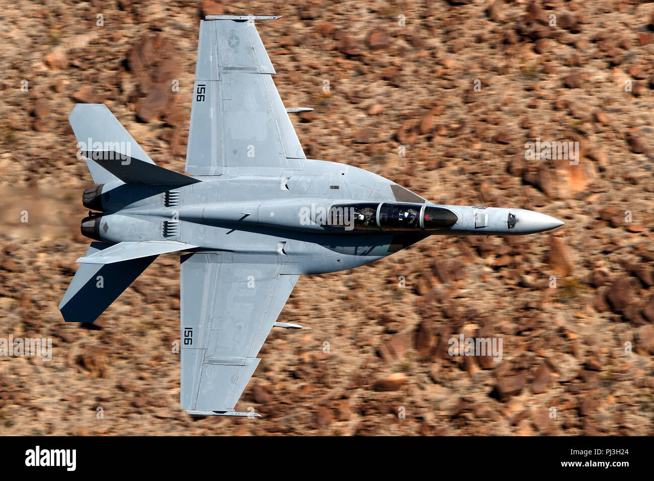 United States Navy Boeing F/A-18F Super Hornet (side 156) from the  VFA-122 Flying Eagles squadron flies low level on the Jedi Transition through Star Wars Canyon / Rainbow Canyon, Death Valley National Park, Panamint Springs, California, United States of America Stock Photo