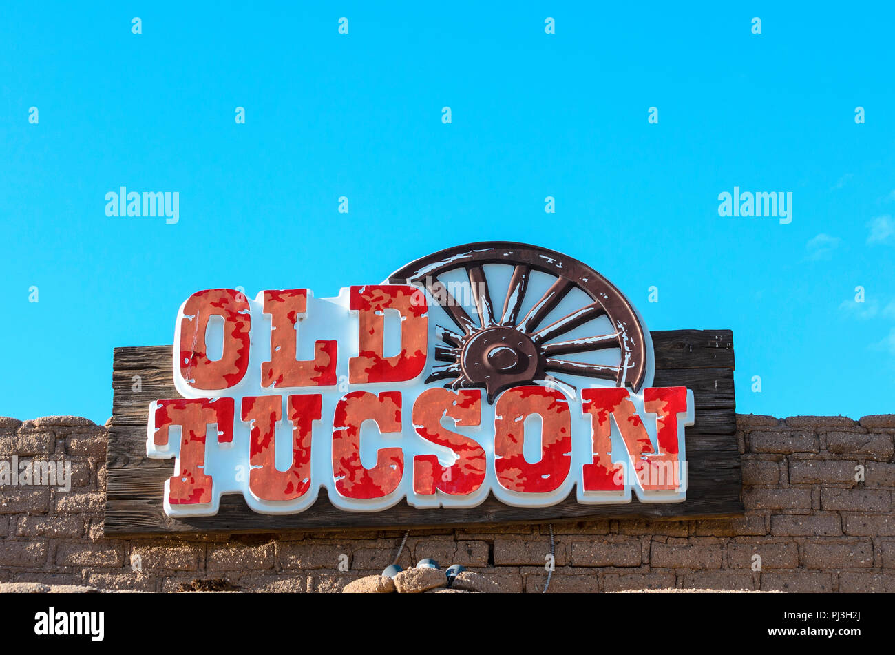 The entrance sign “Old Tucson” with wagon wheel. Stock Photo