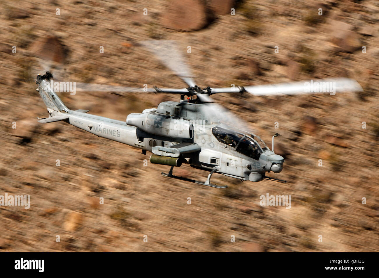 United States Marines Corps Bell AH-1Z Viper (SN 168519) from the Marine Light Attack Helicopter Squadron 169 (HMLA-169) flies low level on the Jedi Transition through Star Wars Canyon / Rainbow Canyon, Death Valley National Park, Panamint Springs, California, United States of America Stock Photo