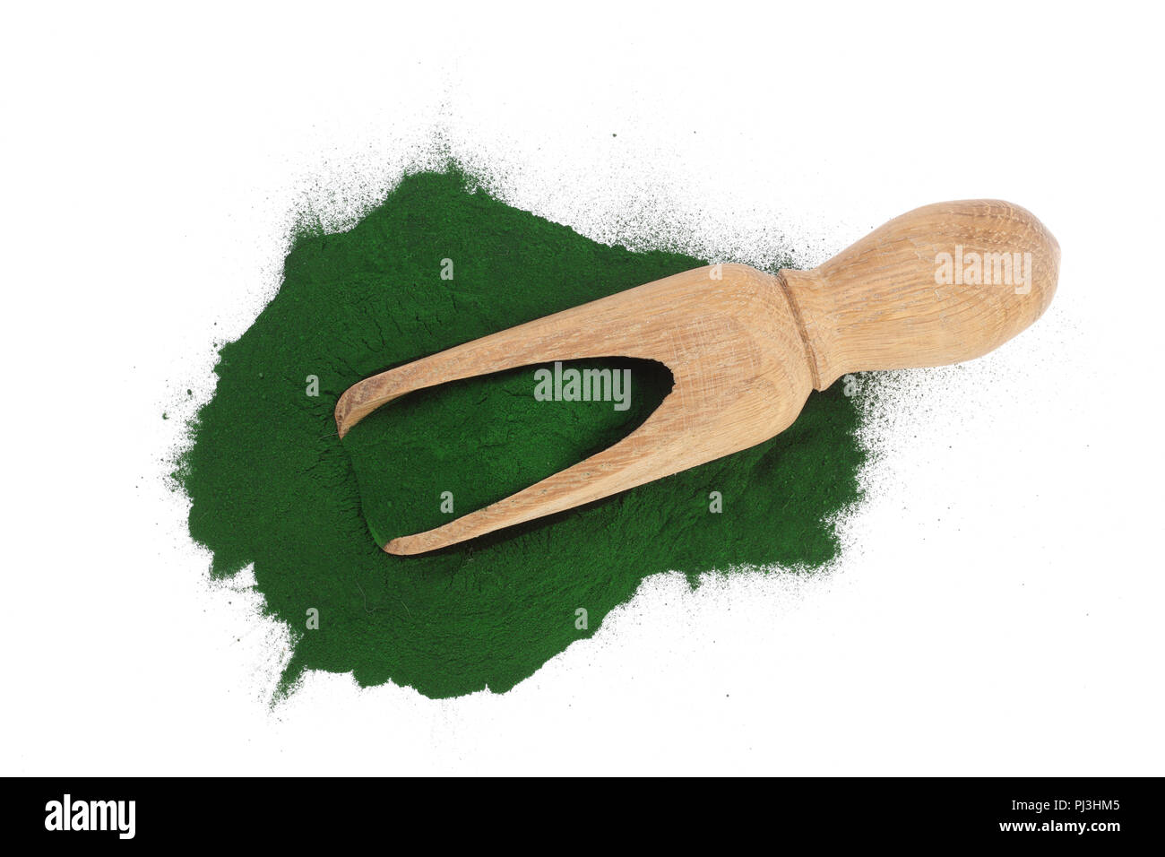 Spirulina algae powder in wooden scoop isolated on white background. Top view Stock Photo