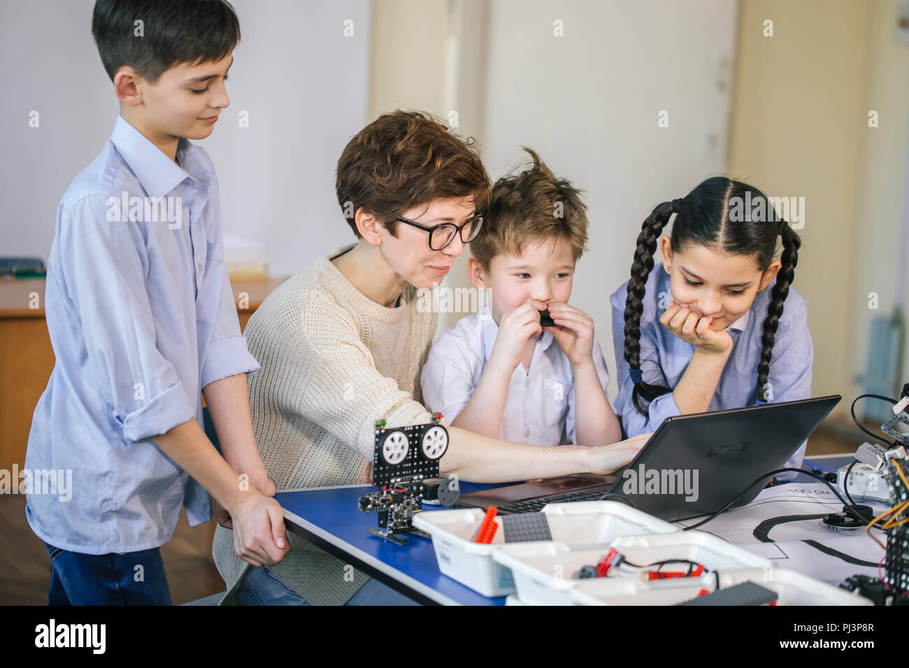 Happy children learn programming using laptops on extracurricular ...