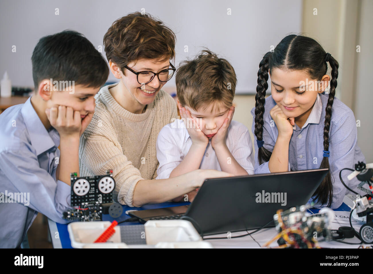 Happy children learn programming using laptops on extracurricular ...