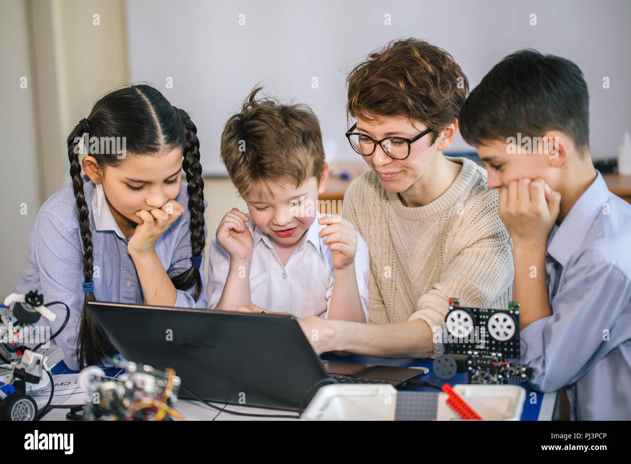 Happy children learn programming using laptops on extracurricular ...