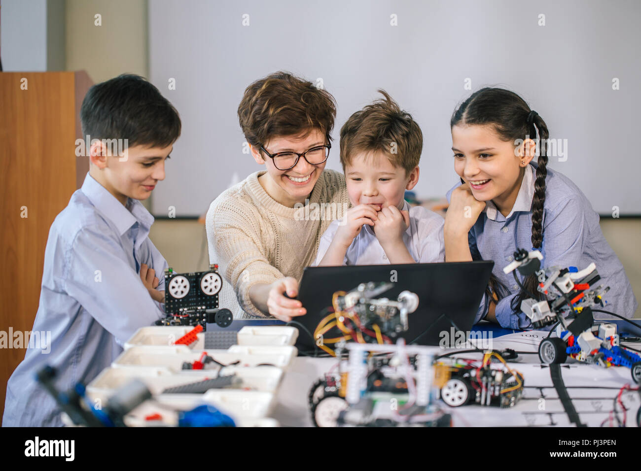 Curious children learn programming using laptops on extracurricular ...