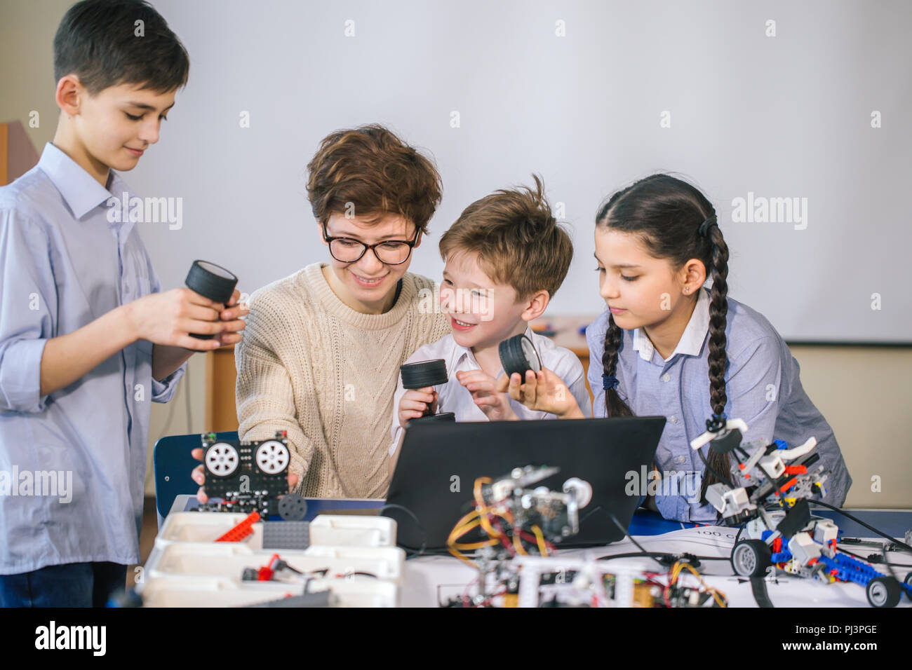 Happy children learn programming using laptops on extracurricular ...