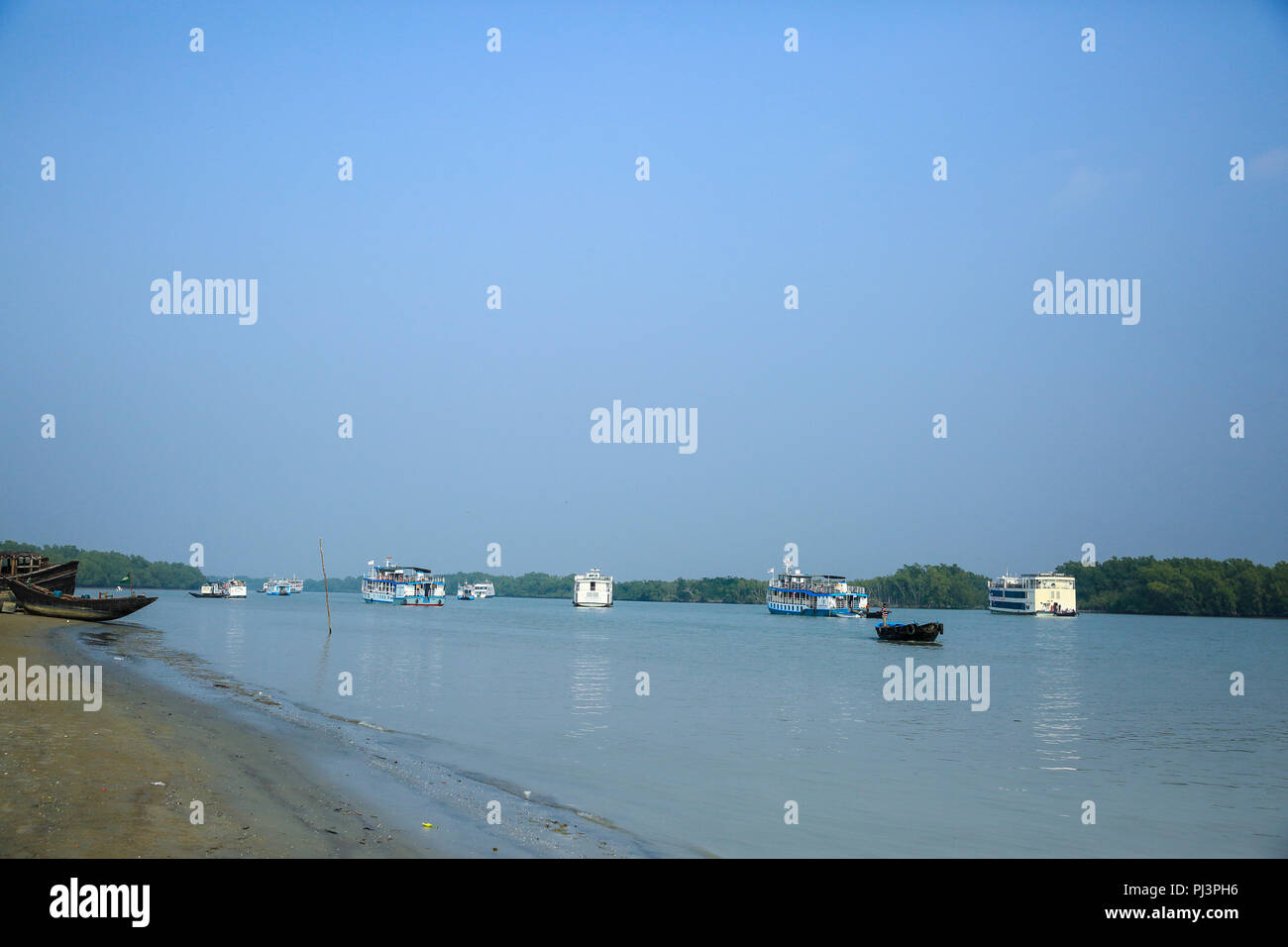 Tourist vessels anchored near the Kotka forest office in the Sundarbans. Bagerhat, Bangladesh. Stock Photo