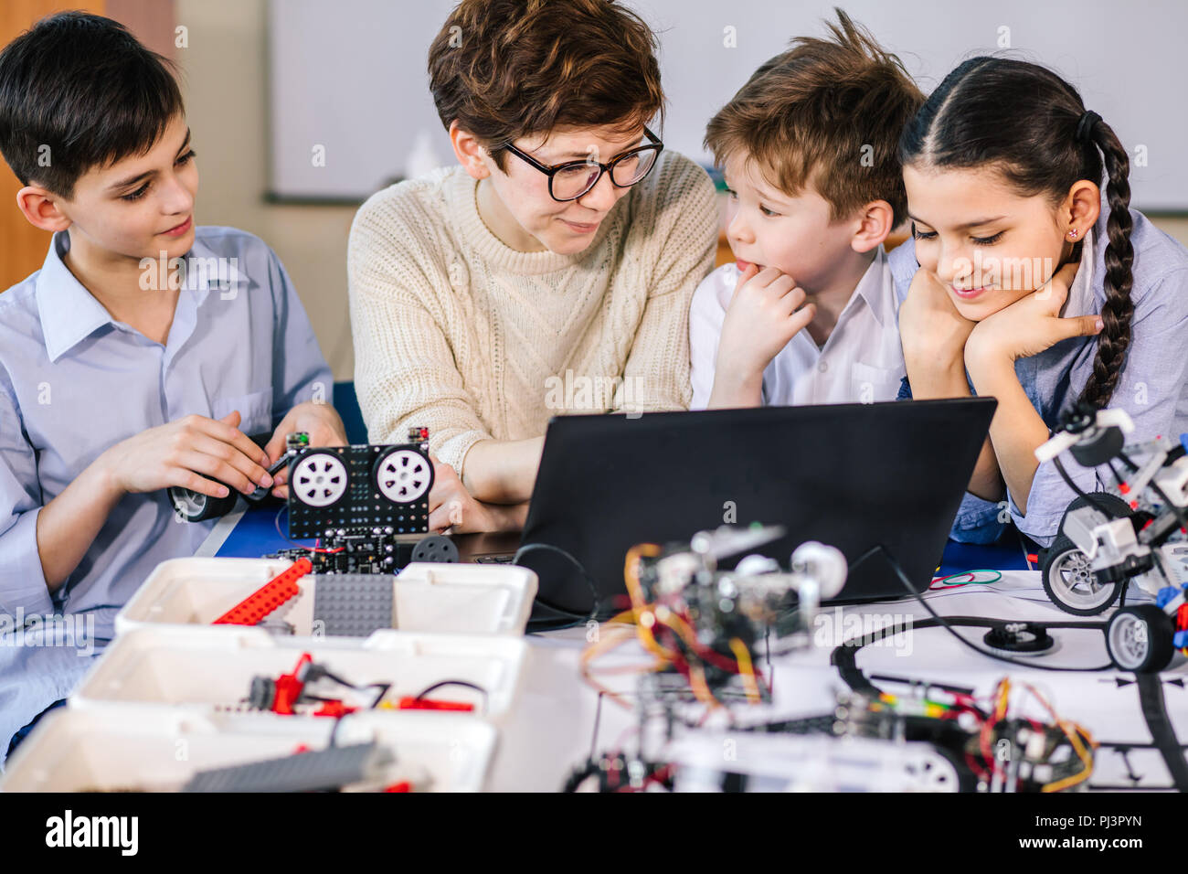 Happy children learn programming using laptops on extracurricular ...