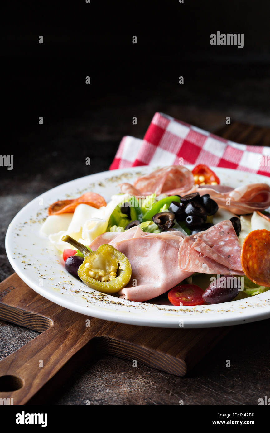 Antipasto platter with marinated vegetables, olives, cheeses and cured