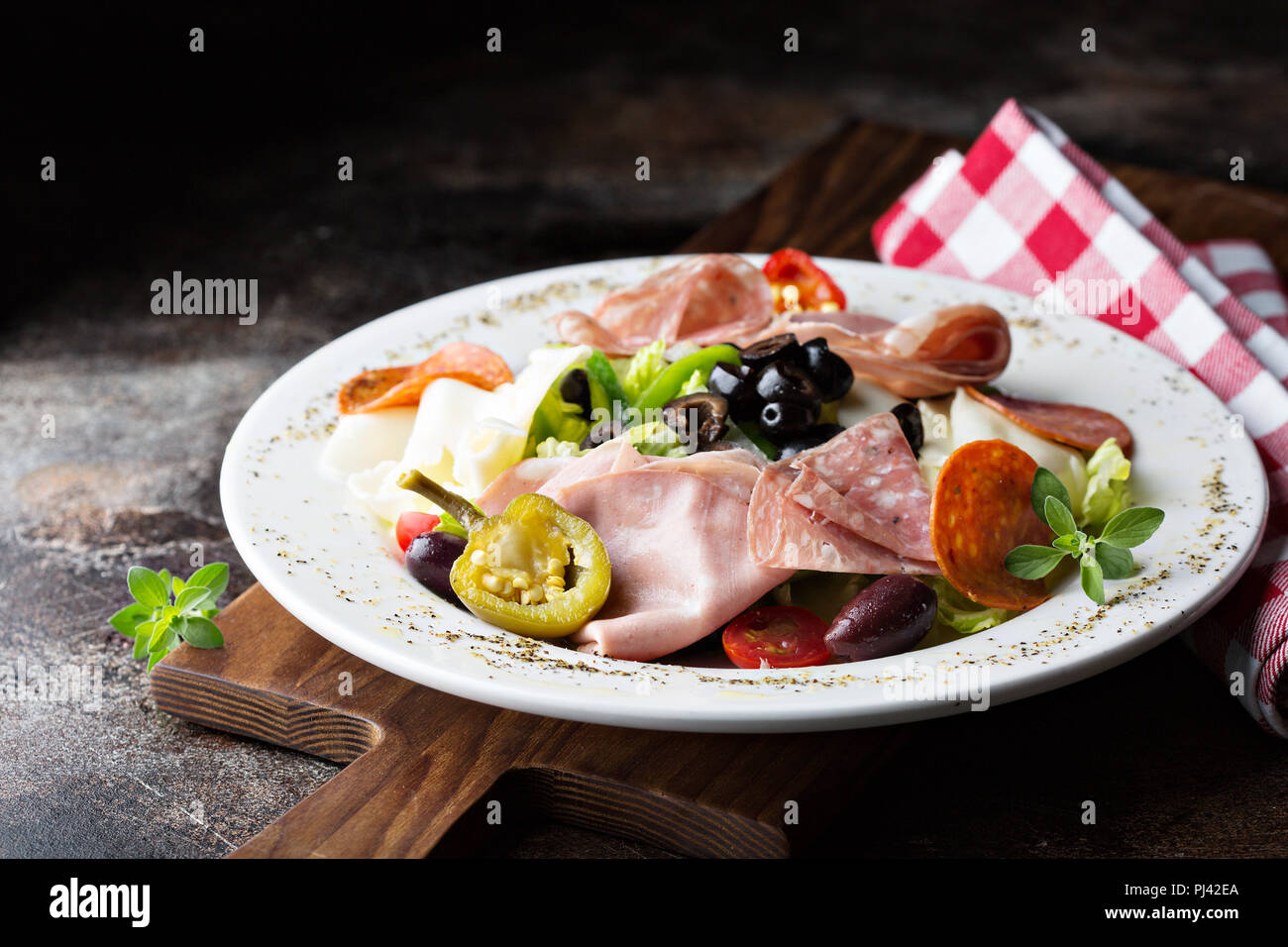 Antipasto platter with marinated vegetables, olives, cheeses and cured