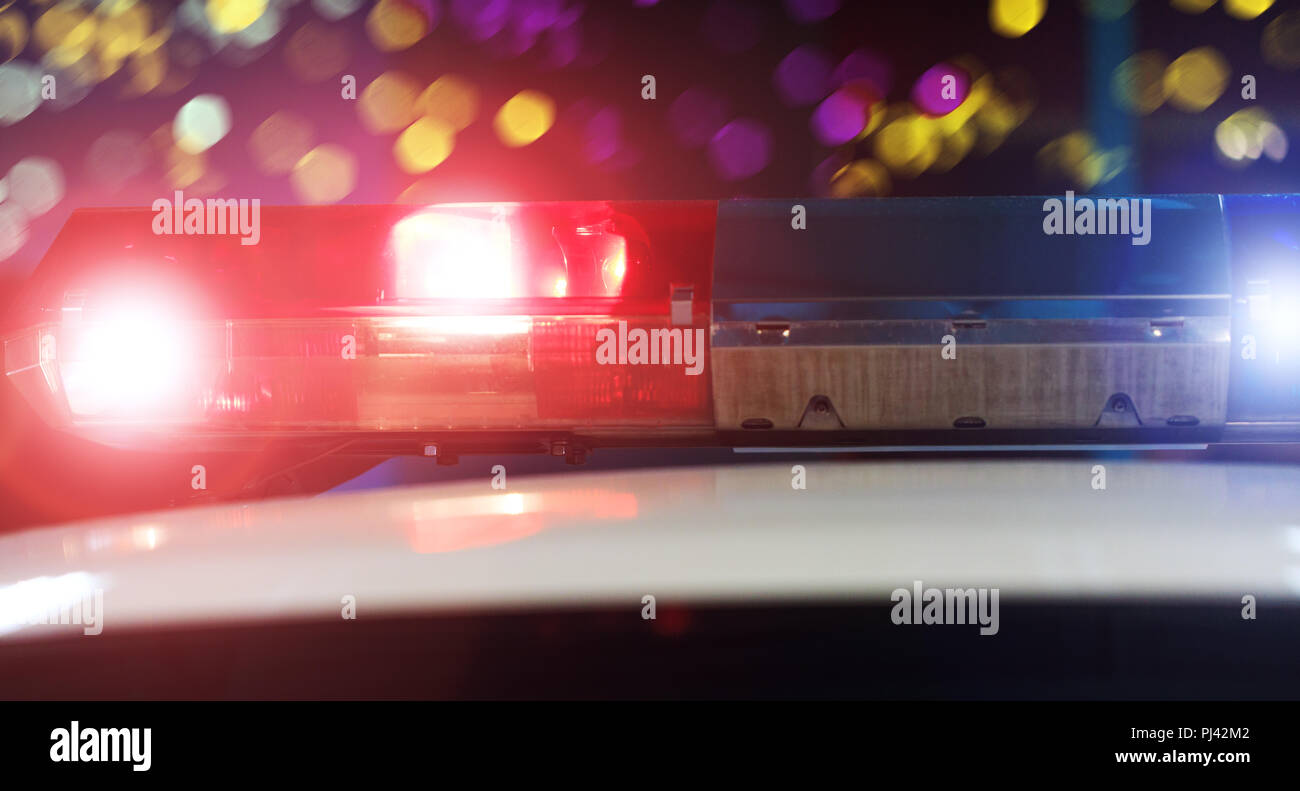 Police patrol car of the specialized unity in the night time. Red and blue flashes on the car of the emergency vehicle. Police lights during traffic s Stock Photo