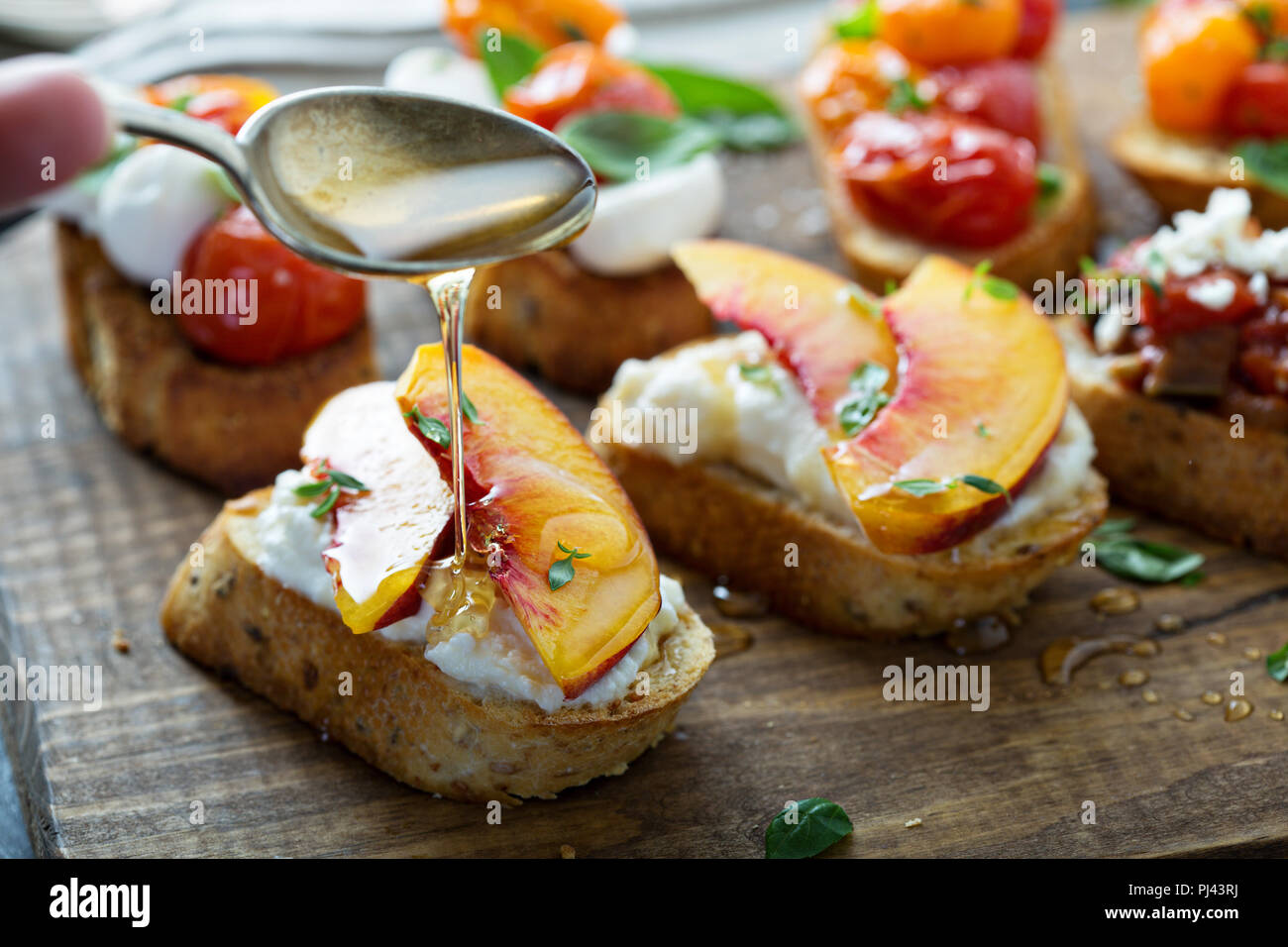Crostini or bruschetta with ricotta, honey and peaches Stock Photo Alamy