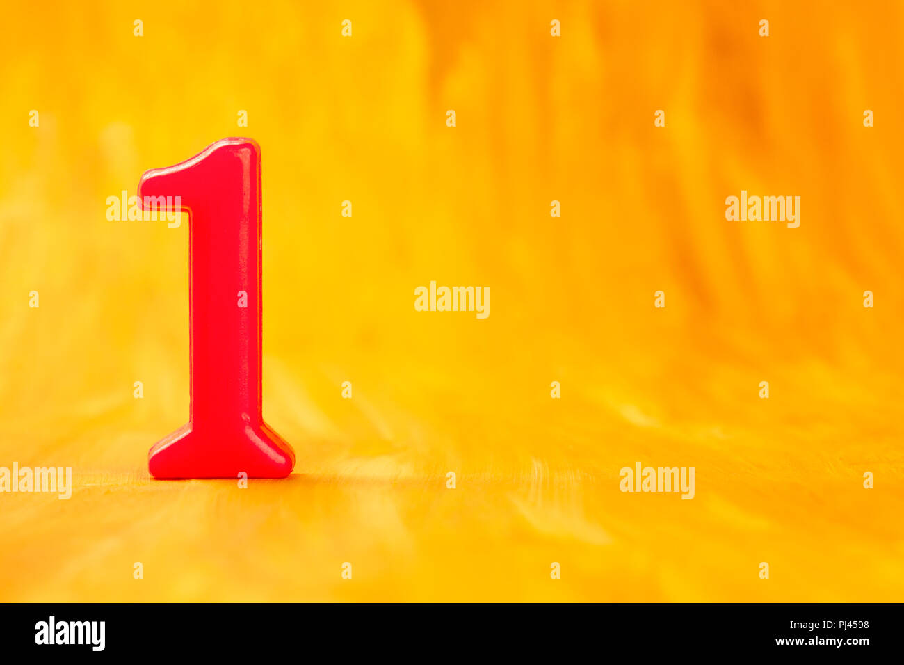 Red number one on a golden background with copyspace Stock Photo - Alamy