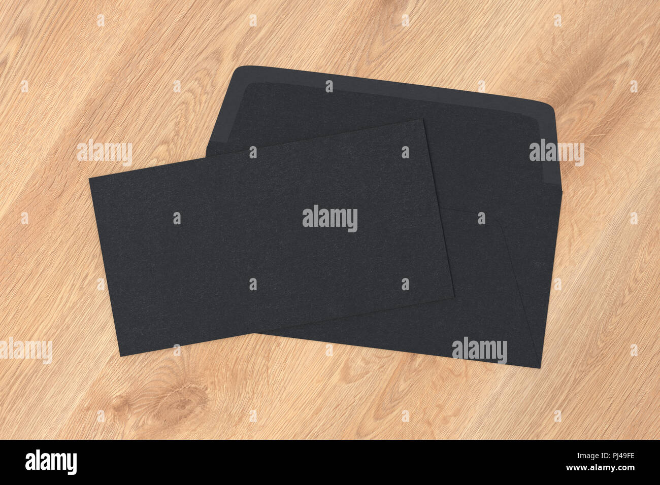 Black blank closed envelope on opened envelope on wooden background. 3d ...