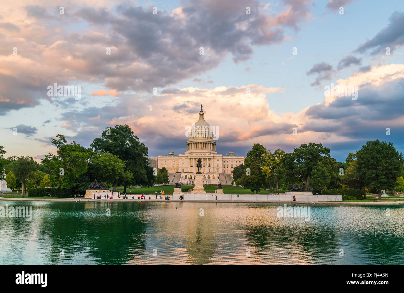 The United States Capitol building at sunset wirh reflection in water. Stock Photo