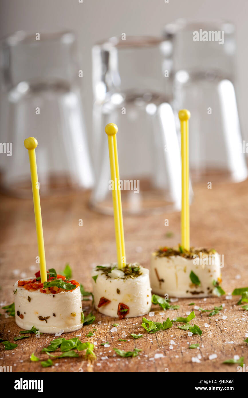 Small appetizer made from cheese and dried vegetables with herbs Stock Photo