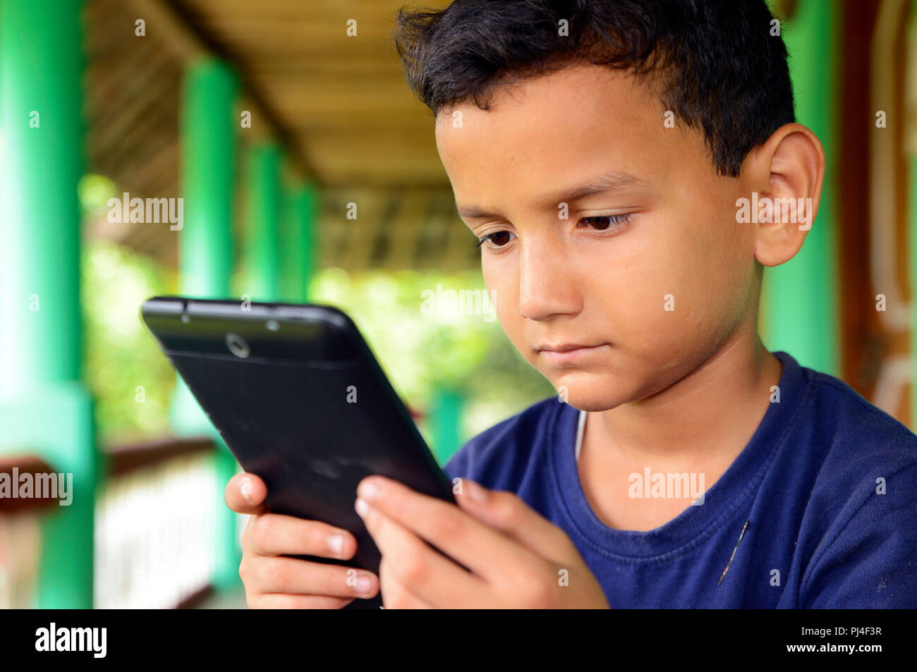 Smiling African Boy Playing Online Games in Class Stock Photo - Image of  phone, modern: 177228872