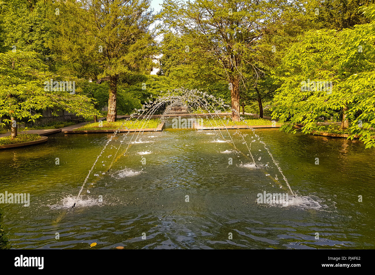 Castle park in summer with fountain in the bright day. Water Environment concept Stock Photo