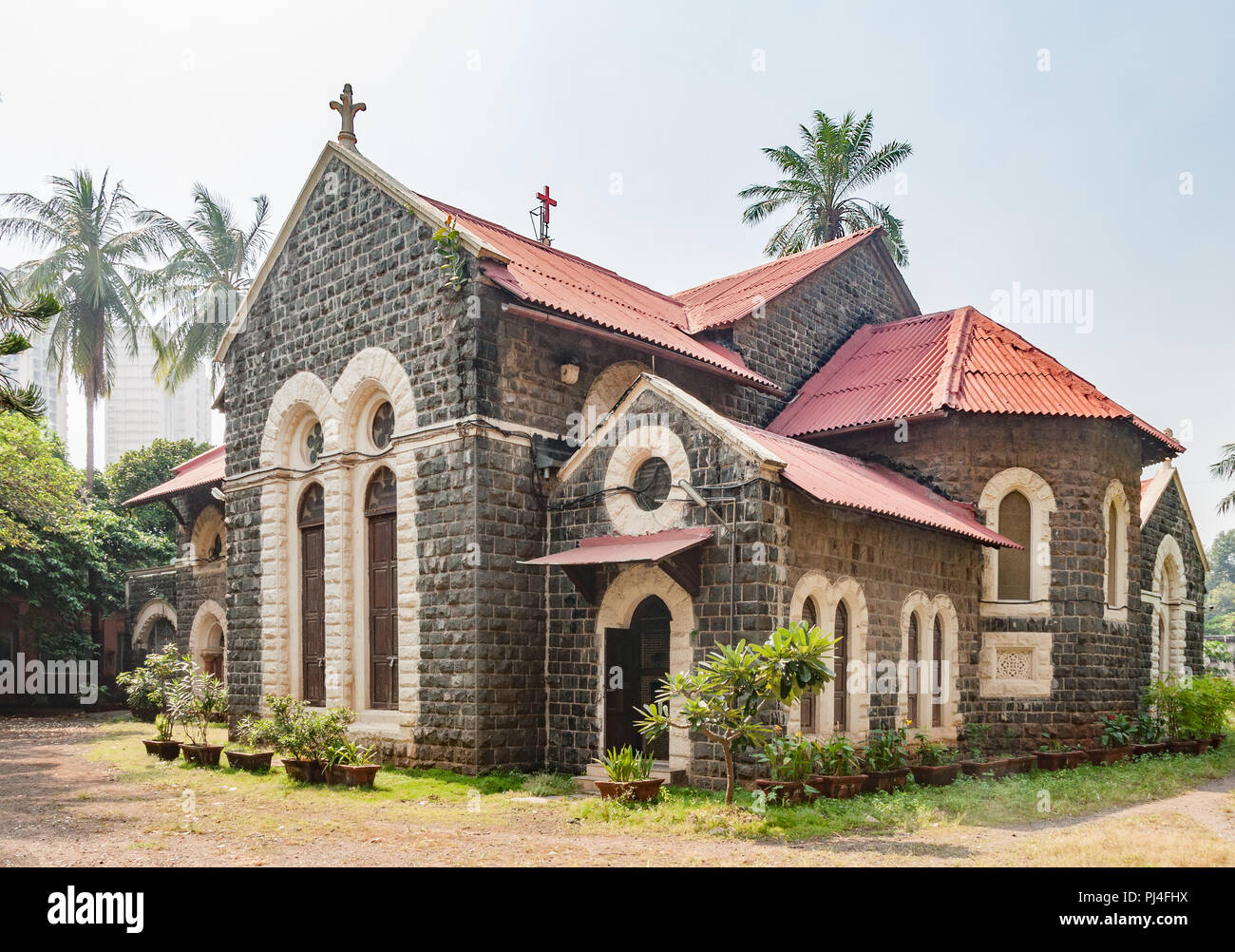 MUMBAI, INDIA – October 23 2017: Stone building and compound of Emmanuel Church (built 1869). Modern buildings in background. Stock Photo