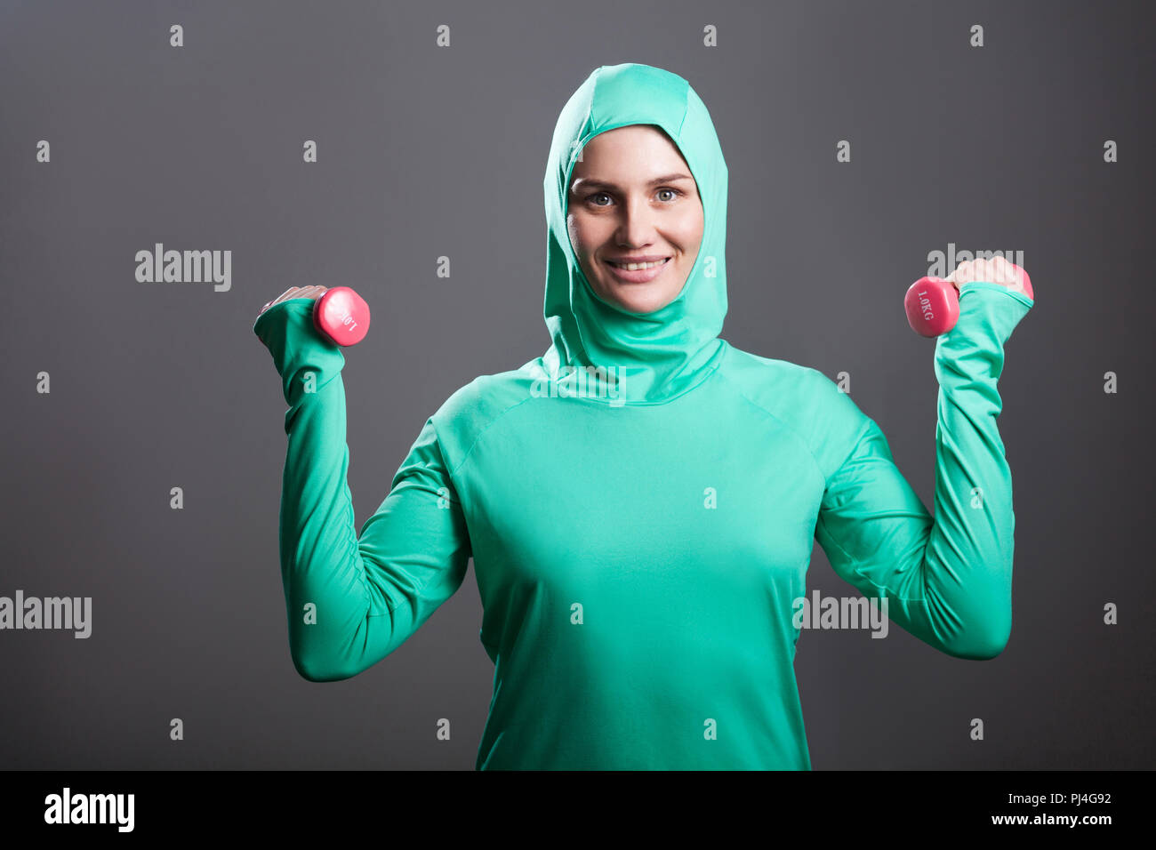 Sporty fit woman, athlete, egyptian and muslim with dumbbells