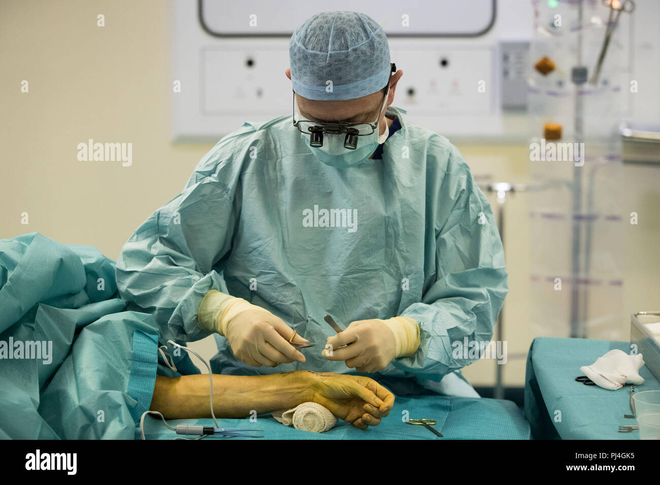 Embargoed to 0001 Wednesday September 5 Carlos Heras-Palou, 53, performing hand surgery at Derby Nuffield Hospital. Mr Heras-Palou, an orthopaedic specialist surgeon, may have had his career saved by a new drug called 'Patisiran'. The rare disease, hereditary transthyretin-mediated amyloidosis (hATTR amyloidosis), progressed and destroyed the nerves in his hands, rendering them useless. However after an 18 month course of Patisiran the condition has halted and reversed. Stock Photo