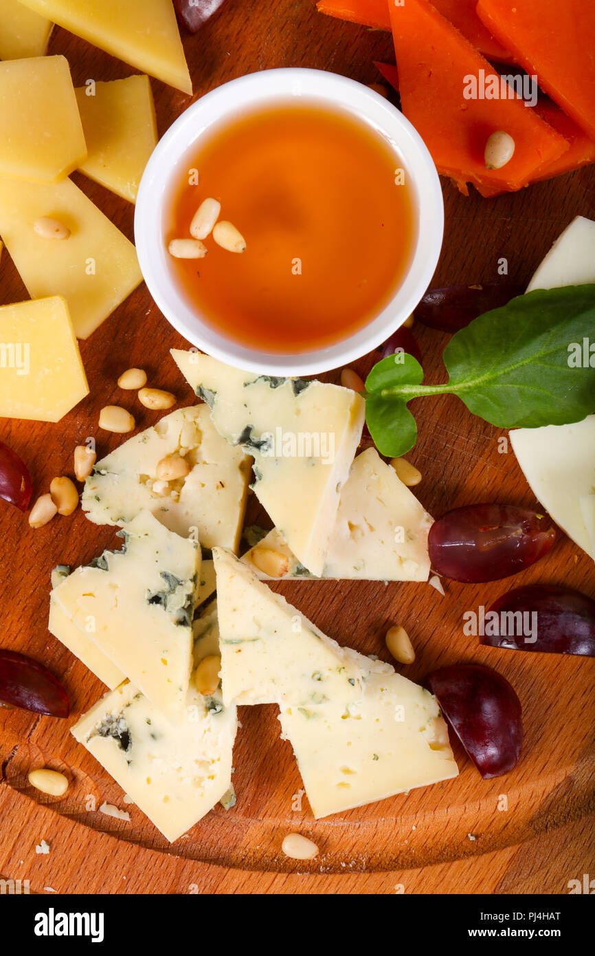 Cheese plate with honey and cedar nuts Stock Photo Alamy