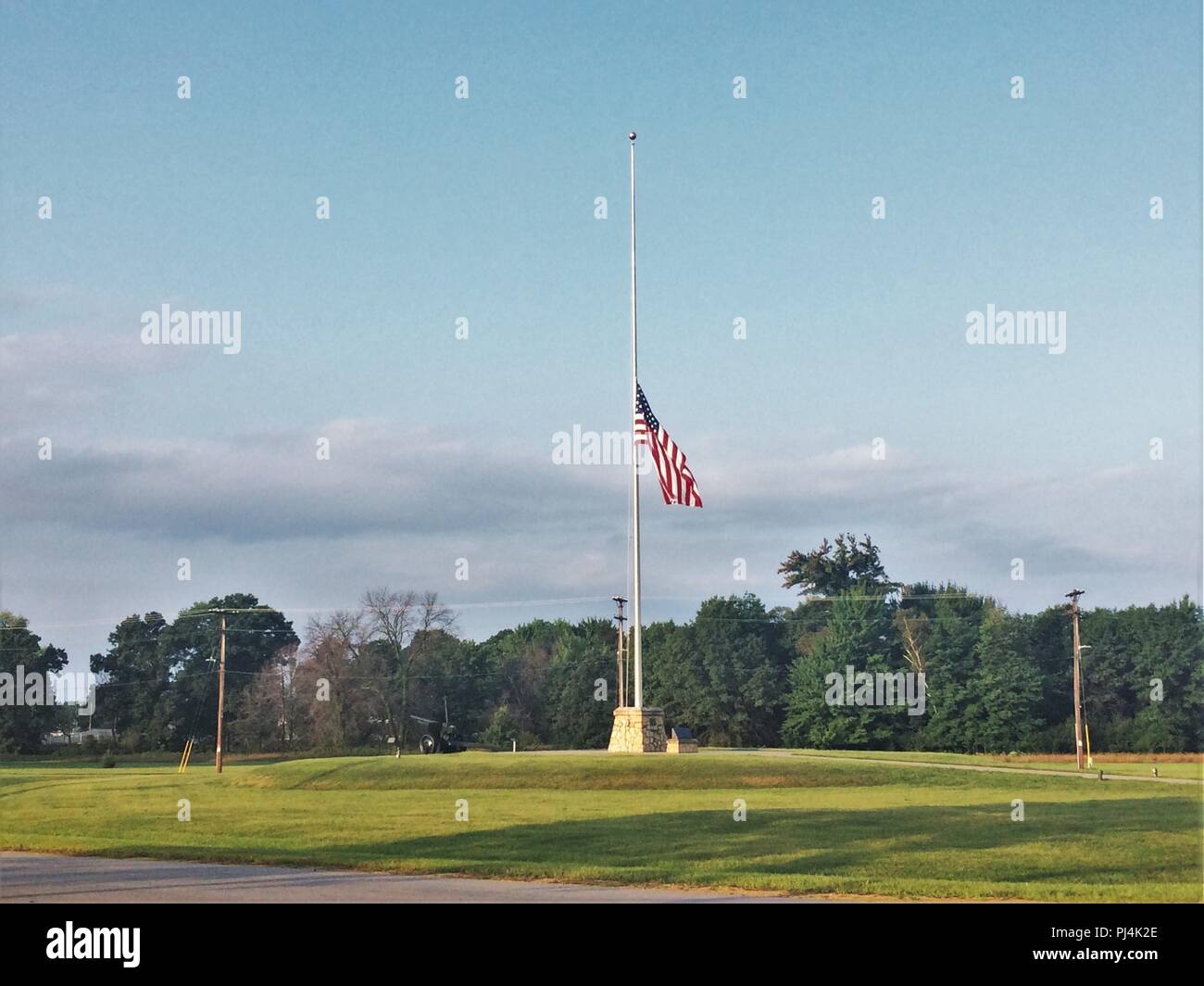 The United States flag flies at half-staff Aug. 28, 2018, at Fort McCoy, Wis., in honor of U.S. Senator John S. McCain III who died Aug. 25. McCain was an American politician and naval military officer who served as a United States Senator from Arizona from 1987 until his death. He previously served two terms in the United States House of Representatives and was the Republican nominee for President of the United States in the 2008 election. According to johnmccain.com, McCain was the son and grandson of distinguished Navy admirals and he graduated from the Naval Academy in 1958. He served as a Stock Photo